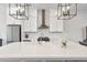 Modern kitchen featuring white cabinets, stainless steel appliances, and a large quartz island at 6785 Pippin Walk, Alpharetta, GA 30005