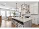 Spacious kitchen featuring an island with bar stools, stainless steel appliances, and modern pendant lighting at 6785 Pippin Walk, Alpharetta, GA 30005