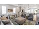 Open-concept living space with comfortable seating, kitchen view, and a modern staircase at 6785 Pippin Walk, Alpharetta, GA 30005