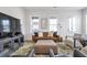 Comfortable living room with a brown leather sofa, neutral decor, and a large TV for entertainment at 6785 Pippin Walk, Alpharetta, GA 30005