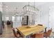 Open-concept living space combining dining area, kitchen and living room with hardwood floors at 6785 Pippin Walk, Alpharetta, GA 30005