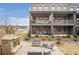 Townhome patio with stone fireplace, seating area, and second-story balconies at 6785 Pippin Walk, Alpharetta, GA 30005