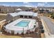 Community swimming pool featuring modern building with outdoor grill and patio area at 6785 Pippin Walk, Alpharetta, GA 30005