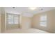 This bedroom features neutral walls, carpet, and windows with blinds for optimal light and privacy control at 1002 Wetherby Way, Johns Creek, GA 30022