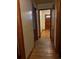 Inviting hallway with gleaming hardwood floors leading to a warmly lit entryway at 1902 Godby Rd, Atlanta, GA 30349