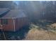 View of side and back of brick home surrounded by lush greenery in a tranquil setting at 1902 Godby Rd, Atlanta, GA 30349