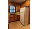 Traditional kitchen with wood cabinets, a double-basin sink, and a white refrigerator at 1902 Godby Rd, Atlanta, GA 30349