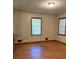 Living room featuring wood floors and two windows at 1902 Godby Rd, Atlanta, GA 30349