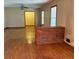 Open living room featuring wood floors and a brick accent piece at 1902 Godby Rd, Atlanta, GA 30349