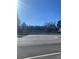 Street view of a building with a dark roof and trees in the background at 1902 Godby Rd, Atlanta, GA 30349
