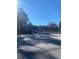 Clear street view with a glimpse of the building, under a bright blue sky with scattered clouds at 1902 Godby Rd, Atlanta, GA 30349