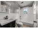 Well-lit bathroom with a vanity, toilet, and a tiled shower-tub combo at 572 Martin Se St, Atlanta, GA 30312