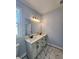 Bright bathroom with double vanity featuring a marble countertop and large mirror at 1064 Eastview Ne Rd, Conyers, GA 30012