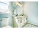 Bathroom with a double vanity, white marble countertops, and tiled floors at 1064 Eastview Ne Rd, Conyers, GA 30012