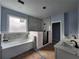 Bathroom featuring a soaking tub, tiled walk-in shower, and double marble vanity at 1064 Eastview Ne Rd, Conyers, GA 30012