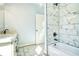 Bathroom features a marble shower, bathtub, and double vanity at 1064 Eastview Ne Rd, Conyers, GA 30012