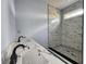 Bathroom with dual marble vanity and glass enclosed tile shower with black trim at 1064 Eastview Ne Rd, Conyers, GA 30012