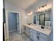 Elegant bathroom with dual vanities, marble flooring, and glass-enclosed shower, reflecting modern design at 1064 Eastview Ne Rd, Conyers, GA 30012