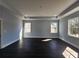 Large bedroom with dark flooring and recessed lights offers space and natural light through two large windows at 1064 Eastview Ne Rd, Conyers, GA 30012