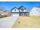 Two-story home featuring a covered front porch, attached two-car garage, and a well-manicured lawn at 1064 Eastview Ne Rd, Conyers, GA 30012