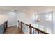 Upstairs hallway with wooden and black metal railing and chandelier at 1064 Eastview Ne Rd, Conyers, GA 30012