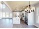 Bright kitchen features an island with white marble countertop, stainless steel appliances and pendant lights at 1064 Eastview Ne Rd, Conyers, GA 30012