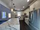 Well-lit kitchen boasts marble counters, stainless steel appliances, and stylish pendant lighting at 1064 Eastview Ne Rd, Conyers, GA 30012