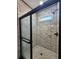 Newly renovated bathroom showcases a sleek glass shower with black trim and hexagon mosaic floor at 1064 Eastview Ne Rd, Conyers, GA 30012