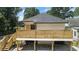 Back exterior features a new wooden deck with stairs and a fenced yard at 203 Sunset Nw Ave, Atlanta, GA 30314