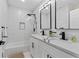 Bathroom with double sinks, white tile, and modern fixtures at 203 Sunset Nw Ave, Atlanta, GA 30314