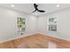 Bright bedroom featuring hardwood floors, a ceiling fan and two windows at 203 Sunset Nw Ave, Atlanta, GA 30314