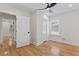 Bright bedroom features hardwood floors, a ceiling fan, and a window at 203 Sunset Nw Ave, Atlanta, GA 30314