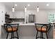 Bright kitchen featuring white cabinets, stainless appliances, and a marble countertop island at 203 Sunset Nw Ave, Atlanta, GA 30314