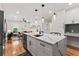 Open-concept kitchen with white cabinets, stainless steel appliances, and a large marble countertop island at 203 Sunset Nw Ave, Atlanta, GA 30314