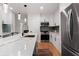 Modern kitchen featuring stainless steel appliances, white cabinetry and a large marble countertop island at 203 Sunset Nw Ave, Atlanta, GA 30314