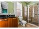 Bathroom with dark granite countertops, wood cabinetry and tile and glass enclosed shower at 3641 Broughton Se Cir, Atlanta, GA 30339