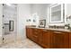 Double vanity bathroom featuring decorative granite countertops and stylish lighting at 3641 Broughton Se Cir, Atlanta, GA 30339