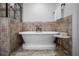 Bathroom showcasing a freestanding tub with beautiful tile surround and decorative marble accent table at 3641 Broughton Se Cir, Atlanta, GA 30339