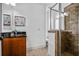 Bathroom featuring granite countertop, modern fixtures, and glass-enclosed tiled shower at 3641 Broughton Se Cir, Atlanta, GA 30339