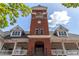 Charming brick clock tower rising above the shops below, with a clock, arched windows and a balcony at 3641 Broughton Se Cir, Atlanta, GA 30339