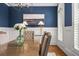 Close up of dining room with a modern chandelier, and a blue accent wall at 3641 Broughton Se Cir, Atlanta, GA 30339