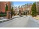 View of the brick entrance of a community, with black iron gates and landscaped grounds at 3641 Broughton Se Cir, Atlanta, GA 30339