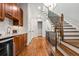 Hallway showcasing hardwood floors, stairs, wet bar and elegant finishes at 3641 Broughton Se Cir, Atlanta, GA 30339