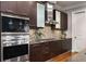 Gourmet kitchen featuring stainless steel appliances, dark wood cabinets, and tile backsplash at 3641 Broughton Se Cir, Atlanta, GA 30339