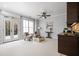 Living room with gray walls, carpet floors, mini bar and light-filled windows at 3641 Broughton Se Cir, Atlanta, GA 30339