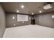 Finished basement featuring a movie screen, projector, and neutral carpeting at 725 Riley Pl, Sandy Springs, GA 30327