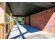 Large back porch with a red brick wall, offering an outdoor living space at 228 W Simon Nw Ter, Atlanta, GA 30318