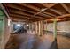 Unfinished basement showcasing exposed ceiling beams and concrete walls, with a staircase at 228 W Simon Nw Ter, Atlanta, GA 30318