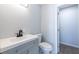 Bathroom with white vanity, stylish black faucet, and modern toilet in gray-toned space at 228 W Simon Nw Ter, Atlanta, GA 30318