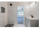 Bright bathroom with white tiles, gray vanity, modern sink, and sleek black faucet at 228 W Simon Nw Ter, Atlanta, GA 30318
